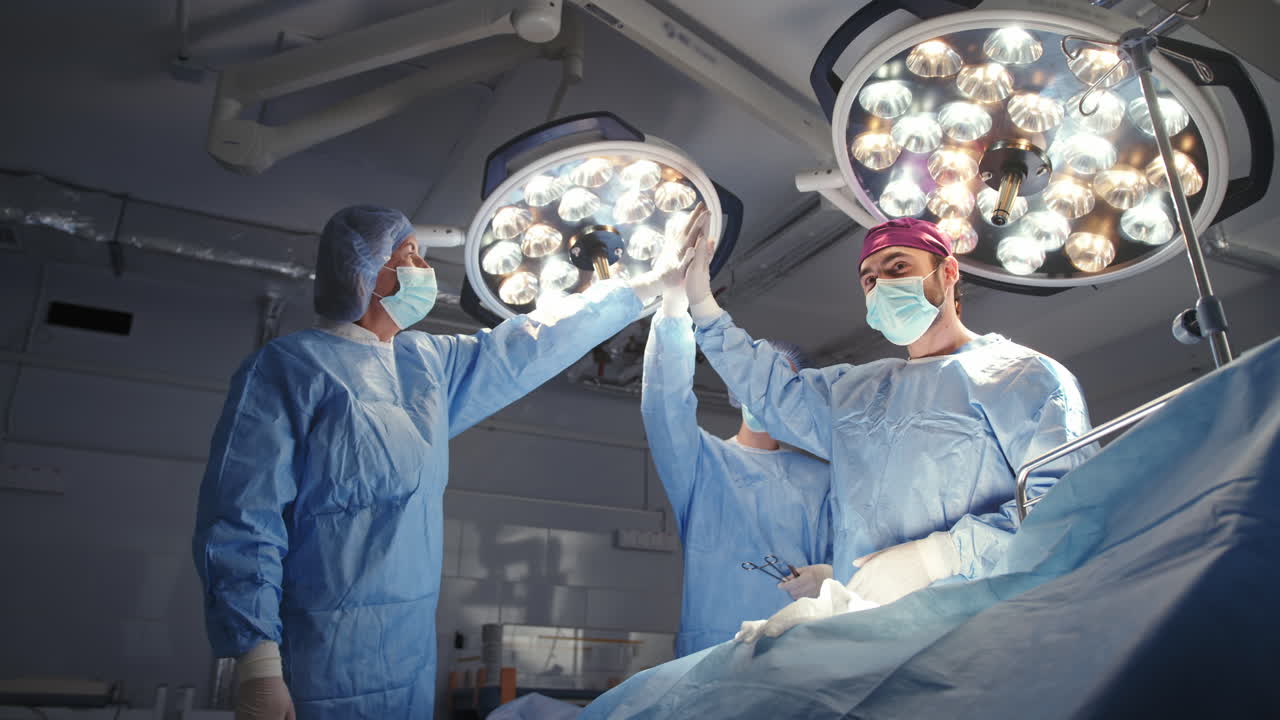 Medical team highfiving after surgery