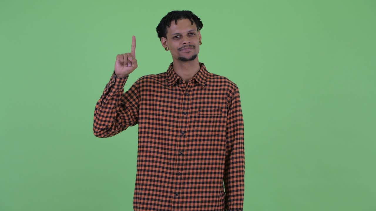 Happy young handsome African man with dreadlocks