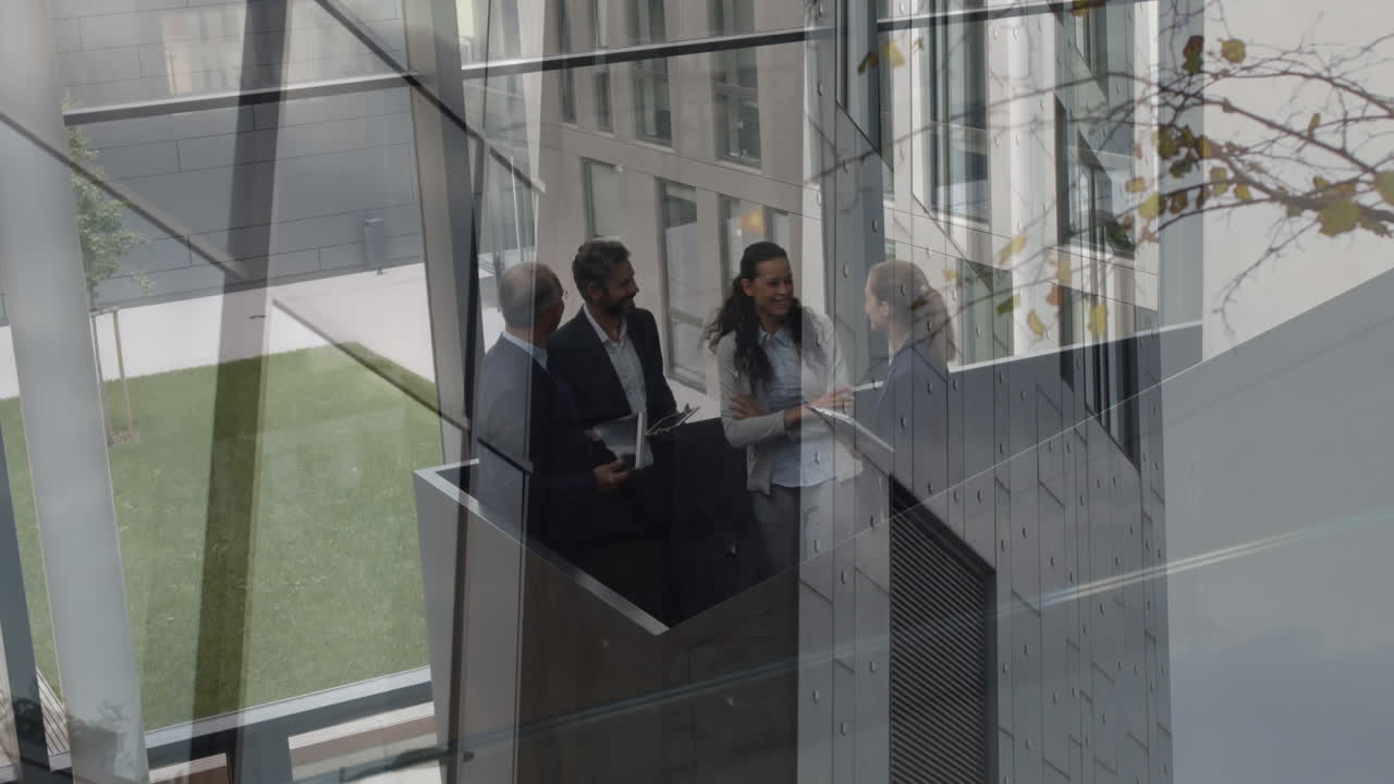 Animation of office building over business people talking in modern office