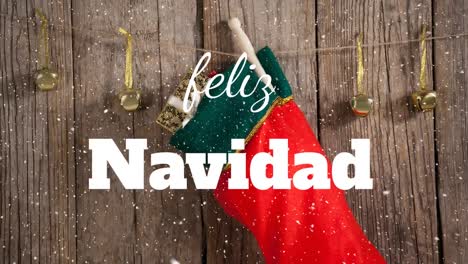 Animation-of-christmas-feliz-navidad-text-over-christmas-stocking-and-bells