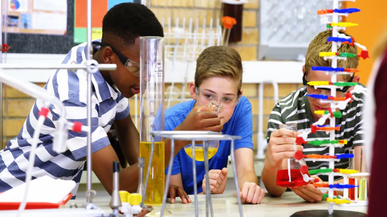 estudiantes experimentando con un modelo de molécula en el laboratorio 4k