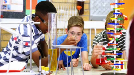 students experimenting molecule model in laboratory 4k