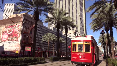 a red new orleans streetcar travels through the downtown area 2