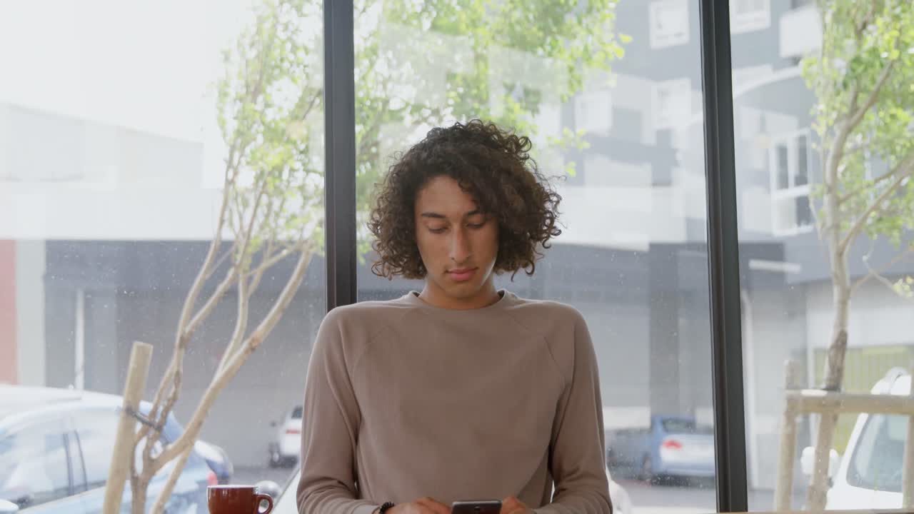 Man using mobile phone in coffee shop 4k