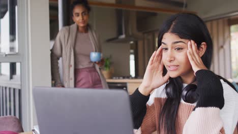 Video-of-nervous-biracial-woman-using-laptop-at-home