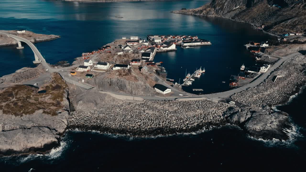 Reine, Lofoten Islands, Nordland, Norway - A Small Fishing Village Nestles Among Rocky Cliffs, With Boats Dotting its Calm Harbor - Orbit Drone Shot