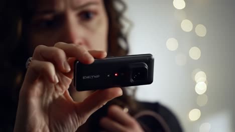 an intense moment unfolds as a woman uncovers a hidden recording device in her home. she expresses shock and concern, realizing the implications of her discovery.