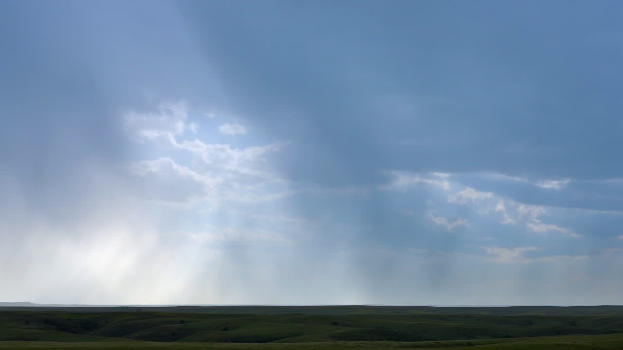 Lightning streaks through rain bands under a summer thunderstorm cloud
