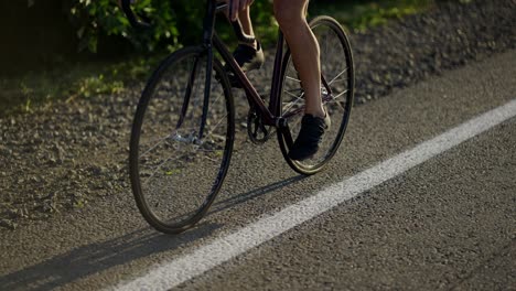 close up of wheels of bicycle spinning while caucasian sportsman riding vehicle