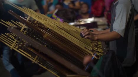 indonesian angklung musician playing traditional gamelan music