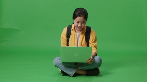 woman sitting on the floor using laptop