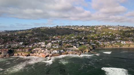 rocky coast with seafront neighborhood at bird rock on la jolla in san diego, california usa