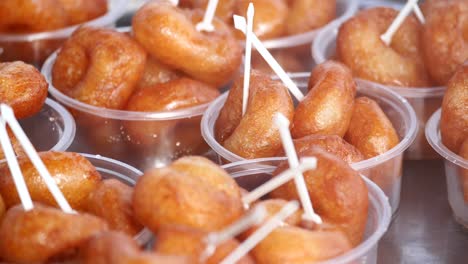 delicious fried doughnuts in small plastic cups