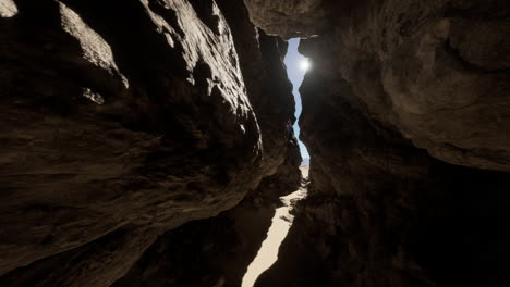 a narrow path between two rock formations in the desert