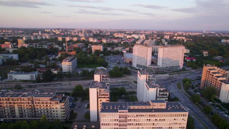 Ascending-aerial-view-of-residential-blocks-in-Krakow-at-pink-colored-sunrise,Poland