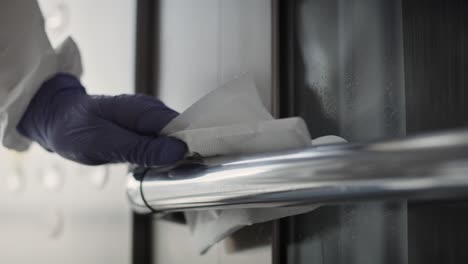 handheld video of hands disinfecting a handrail