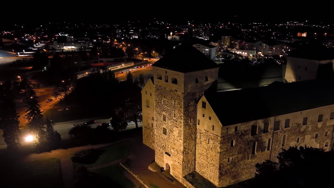 Aerial view circling the entrance to the Turku castle, night in Abo, Finland