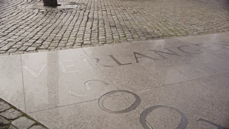 wide pan of edge of amsterdam homomonument with a written inscription