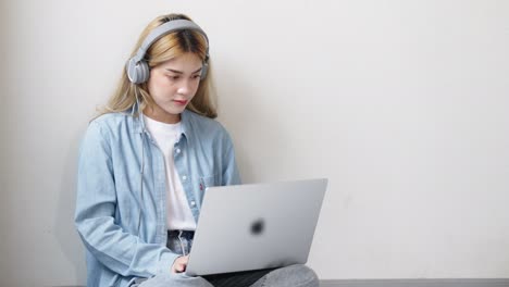 two asian girls student partners are working on a laptop help study together