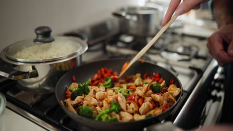 stir-frying vegetables in the kitchen