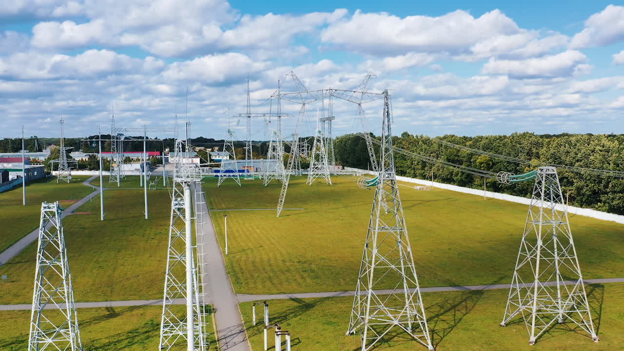 Energy distribution. Electricity pylons on field. Electricity transportation industry in summer. Energetics. Power lines with wires.