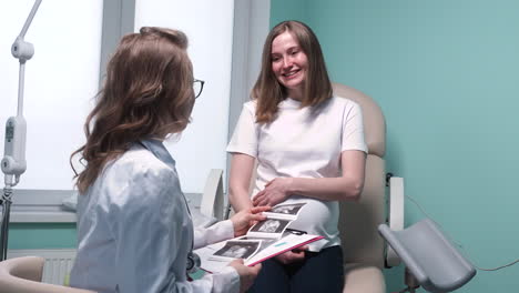 gynecologist shows the ultrasound images to her pregnant patient