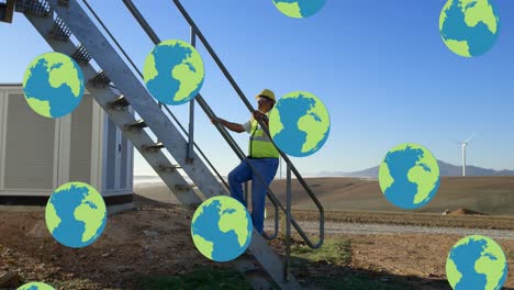 animación de globos sobre ingeniero masculino biracial y turbina eólica