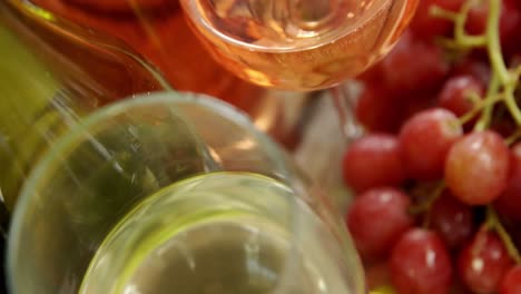 various grapes and wines on wooden plank