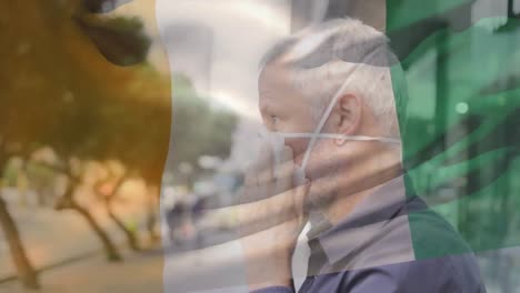 Animación-De-La-Bandera-De-Costa-De-Marfil-Ondeando-Sobre-Un-Hombre-Con-Mascarilla-Durante-La-Pandemia-De-Covid-19