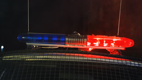 Close-Up-Of-The-Red-And-Blue-Lights-Blinking-On-The-Roof-Of-Police-Car-Outdoors