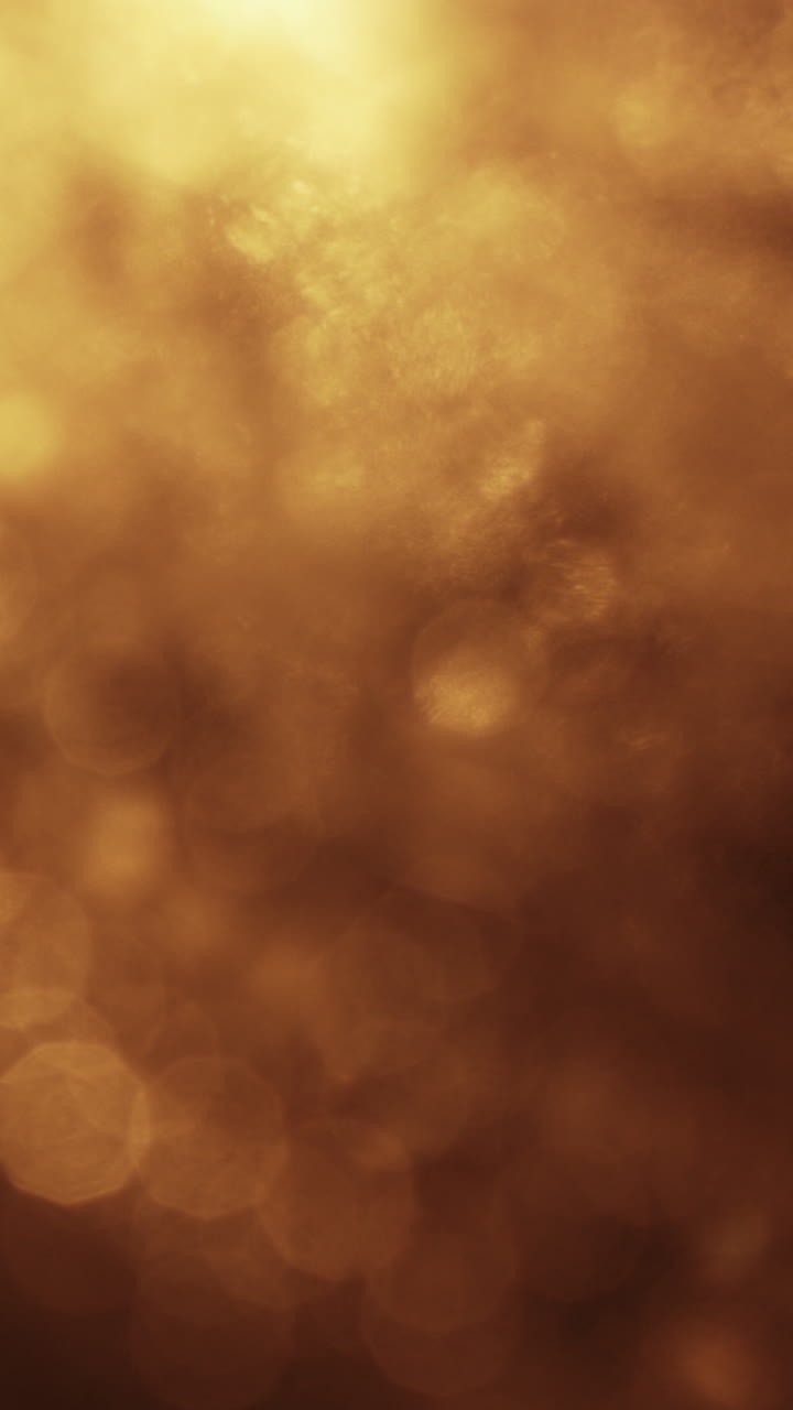 Sfondo astratto in movimento con luci bokeh dorate calde
