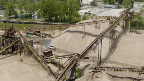 Conveyor-System-With-Car-Driving-Through-Sand-Pit-In-Van-Buren,-Arkansas