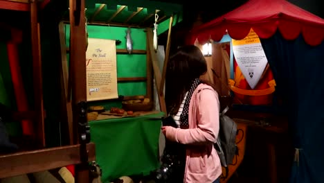 tourist woman in a recreation of an old medieval fair in dublin at dublinia museum