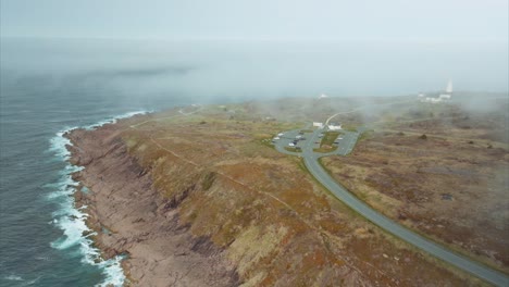 lighthouse hidden in fog along coast of eastern canada