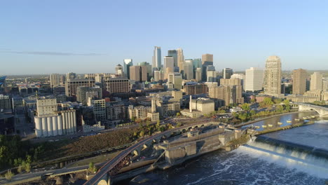 aerial of saint anthony falls and downtown minneapolis on sunny morning with blue sky