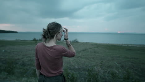 woman leaving van and enjoying lake view