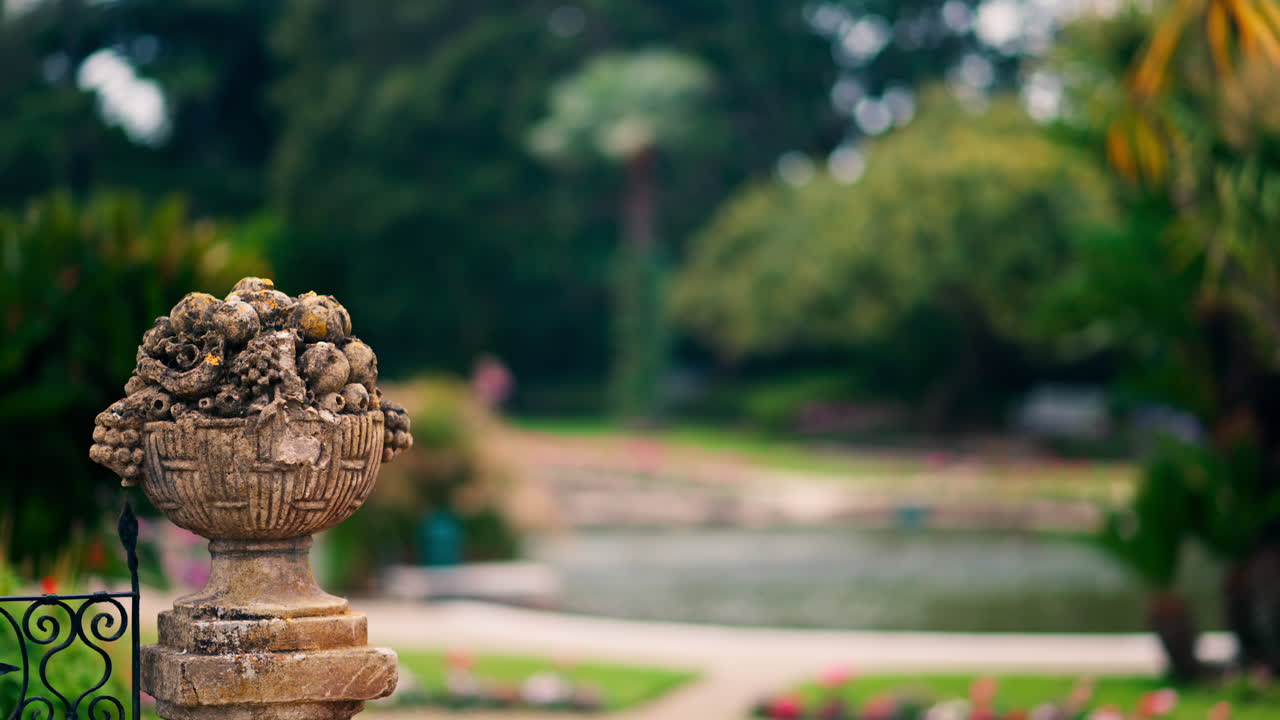 Close up of a decorative stone pillar in the courtyard of Villa Ephrussi de Rothschild with a blurred view on the background