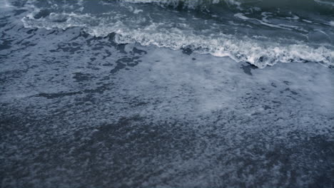 blue waves crashing ocean background. water foam splash in sea nature tsunami.