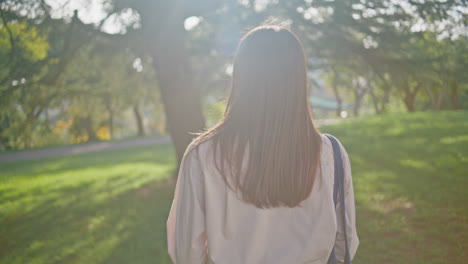 tranquil explorer enjoying morning stroll on green sunny park closeup. girl walk