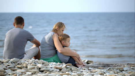 Family-sits-on-the-beach