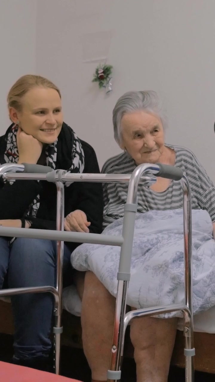Famiglia in visita dalla nonna anziana e che scatta una foto con lei