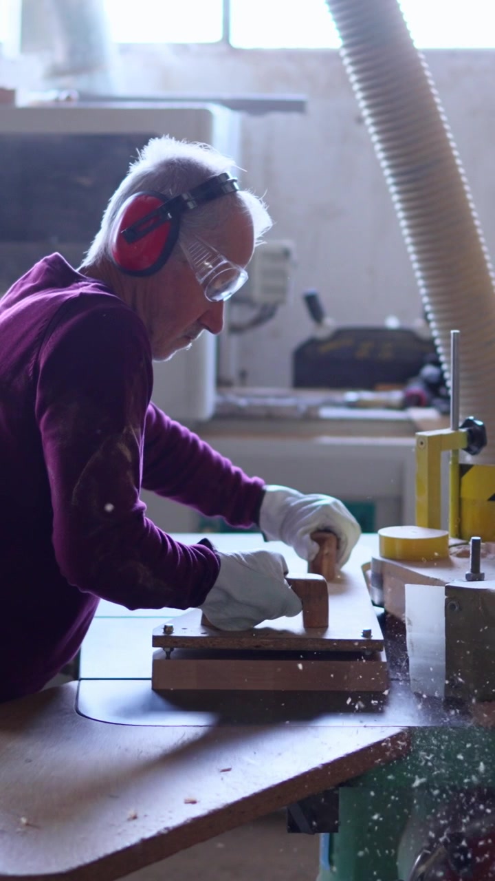 Skilled Woodworker Shaping Wood with a Machine in a Workshop