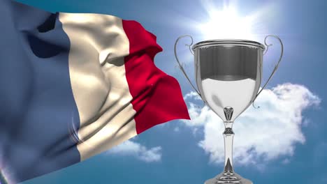 french-flag-next-to-trophy-on-sunny-day