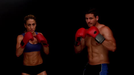 Strong-couple-punching-towards-camera-together