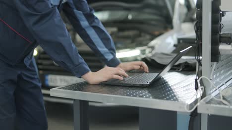 mechanic using laptop for car repair