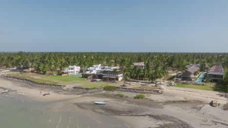 Tropical beach resort with kitesurf hotels, palm trees and lagoon in Ilha do Guajiru