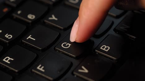 pushing g button on the black keyboard