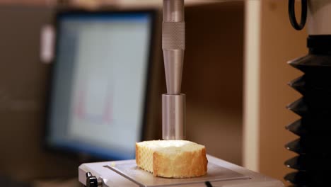 machine punching hole in piece of bread