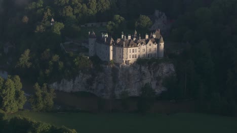 Famous-Walzin-castle-on-natural-cliff-next-to-river,-aerial