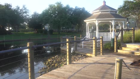 gazebo next to a pond on a beautiful sunny morning